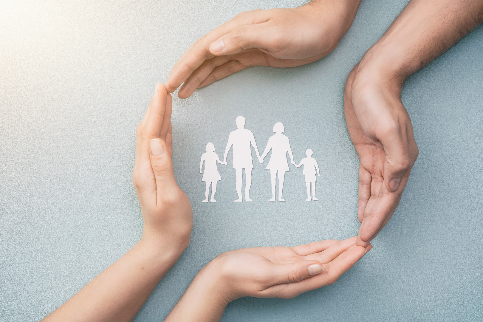 Hands,With,Cut,Out,Paper,Silhouette,On,Table.,Family,Care